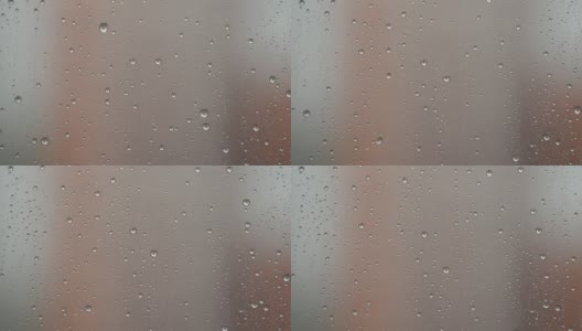 雨滴从窗户上流下的微距摄影。窗外的雨高清在线视频素材下载