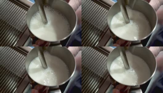 用蒸汽棒在浓缩咖啡机上蒸牛奶高清在线视频素材下载