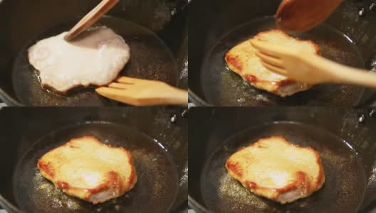 厨师的手把热煎锅里的一块炸过的肉翻过来。高清在线视频素材下载