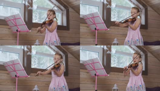 可爱的小小提琴家在阁楼练习高清在线视频素材下载