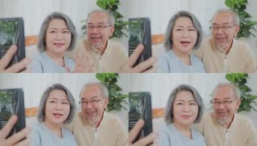 亚洲老年夫妇的特写，老年妇女和老年男子使用手机视频通话与儿子，女儿和在家里与孙辈交谈。祖父母对通过互联网交流感到高兴高清在线视频素材下载