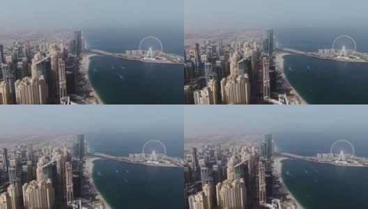 从四轴飞行器垂直平移。迪拜，海滩和摩天大楼的航拍。高清在线视频素材下载