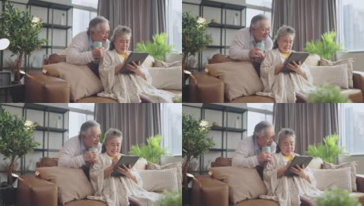 亚洲老年退休夫妇在沙发上与家人一起享受视频通话，幸福地笑着笑着，快乐地呆在家里，亚洲老年成熟成人居家隔离期概念高清在线视频素材下载