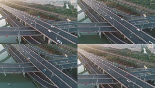 鸟瞰图的道路交叉口与移动的汽车。道路立交或高速公路交叉路口，城市交通繁忙，在道路上超速行驶。高清在线视频素材下载