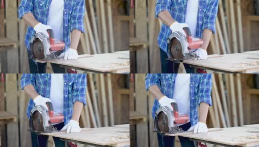 男木匠正在用台锯锯木头。工作时使用卷尺的年轻木匠。高清在线视频素材下载