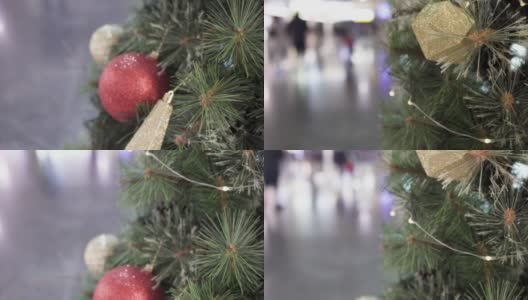 公共区域的圣诞树上挂着闪亮的圣诞装饰品。从下往上倾斜射击。高清在线视频素材下载