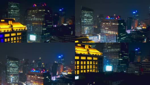 无人机拍摄上海金融区大楼的4K鸟瞰图，带led广告屏幕视图附近的东方明珠塔，中国上海。晚上的时间高清在线视频素材下载