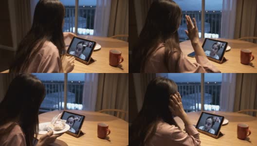 两个亚洲女人在家里通过视频电话聊天，保持社交距离高清在线视频素材下载