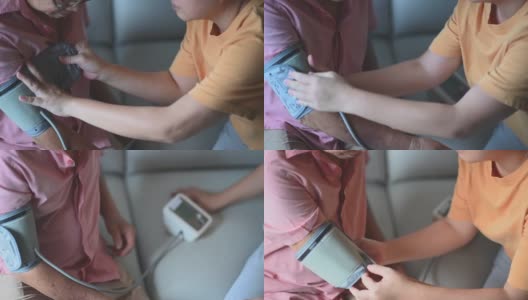 在女儿的帮助下，一名亚裔华人老人正在检查血压高清在线视频素材下载