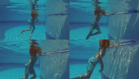 一个男孩在游泳池的水下游泳高清在线视频素材下载