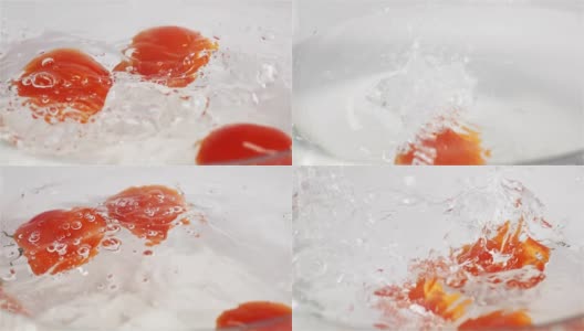 几个红色的西红柿扑通一声掉进水里高清在线视频素材下载