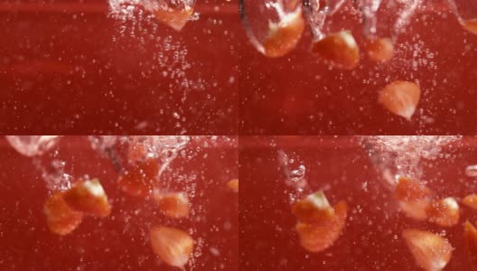 成熟的草莓片漂浮在果汁中高清在线视频素材下载