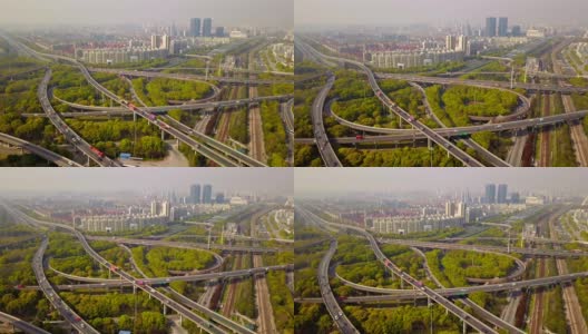 公路路口的汽车鸟瞰图，绿树环绕。桥梁、道路或街道在建筑结构和交通概念上。前视图。城市城市，中午，中国上海。高清在线视频素材下载
