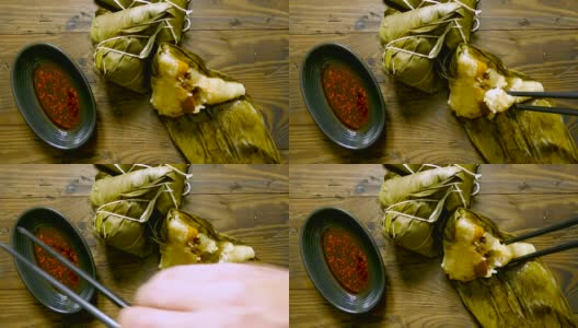 用筷子夹着辣椒吃粽子高清在线视频素材下载