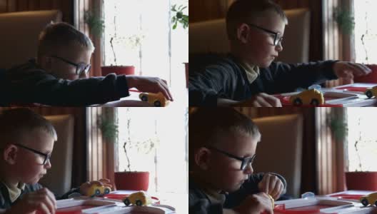 一个男孩正在家里玩玩具车高清在线视频素材下载