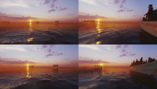 难民在小船上迎着美丽的日出，在海上航行高清在线视频素材下载