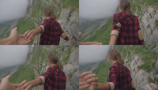 慢镜头:一对夫妇手牵着手，男人带着朋友去山脊。在山间小道上领路高清在线视频素材下载