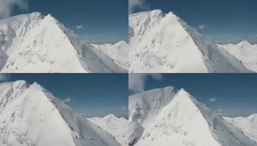 一组滑雪者和滑雪板攀登在当地滑雪胜地的雪山高清在线视频素材下载
