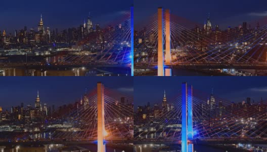 在灯火通明的科修斯科大桥上，曼哈顿中城天际线的夜景。航拍视频与快速平移摄像机运动。高清在线视频素材下载