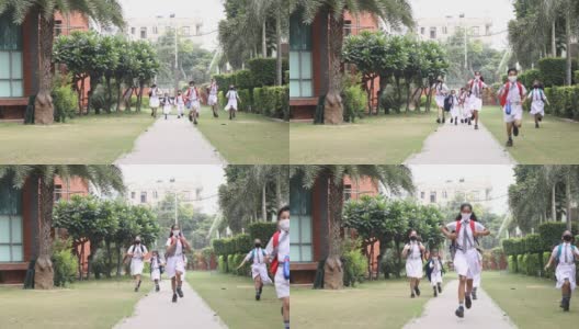 孩子们戴着防护口罩跑向学校高清在线视频素材下载