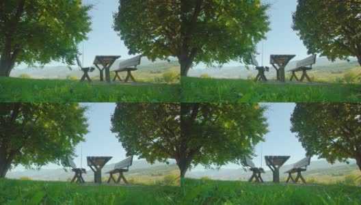 有桌子的木凳放在草地上，背对着山谷高清在线视频素材下载