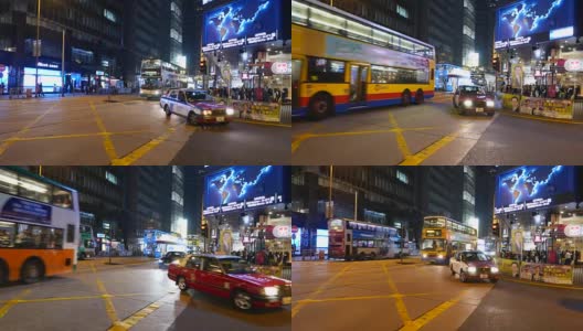 看着快速移动的双层巴士，夜晚，香港的某个路口高清在线视频素材下载