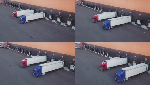 航拍仓库装卸码头，卡车用半挂车装卸货物高清在线视频素材下载
