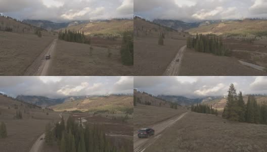 空中黑色越野车行驶在道路槽河谷向落基山脉高清在线视频素材下载