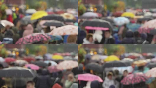 人们在繁忙的商业街撑着雨伞挡雨。真正的时间。黄色雨伞和黄色雨衣。人们在雨中带着雨伞上下班。模糊的散景。城市阴雨天的自然背景高清在线视频素材下载