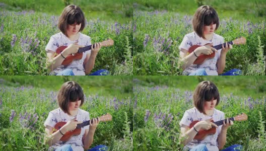 年轻漂亮的女孩在弹尤克里里吉他高清在线视频素材下载