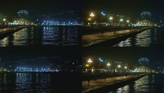 晚上，人们走在克里米亚黑海的长廊上高清在线视频素材下载