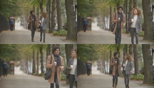 一对时尚的夫妇慢镜头走在城市的秋街高清在线视频素材下载
