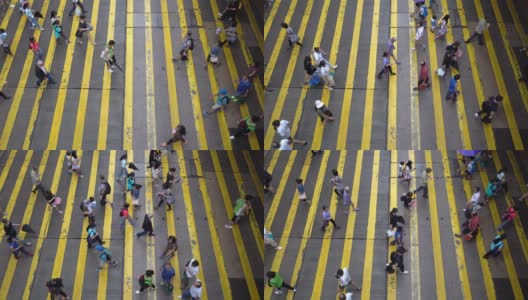 鸟瞰图的人群走在街道上斑马线或人行横道。商业交通道路在繁忙的城市。香港市区。高清在线视频素材下载