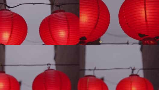 晚上走在中国传统街道上，美丽的圆形红灯笼挂着，摇摆着，这是农历新年节日的概念。高清在线视频素材下载