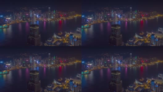 飞行在香港城市维多利亚港市中心夜光航拍全景，4k时间间隔高清在线视频素材下载