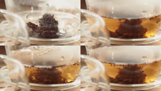 茶壶将红茶倒入玻璃杯中，特写微距，选择性聚焦高清在线视频素材下载
