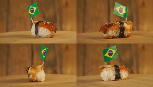 寿司配上鱼、米饭、海藻和巴西小旗放在上面，在一个木制的转盘上旋转。高清在线视频素材下载