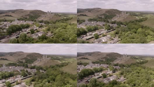 风景航拍的斯瓦尼奇铁路蒸汽火车经过考夫城堡的中世纪遗迹，英国多塞特高清在线视频素材下载