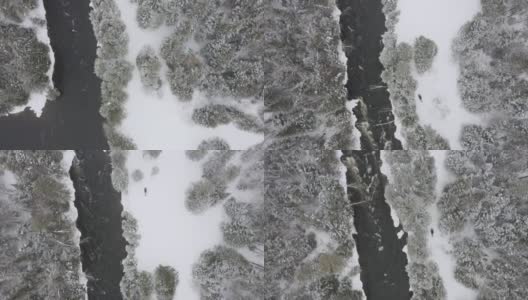 鸟瞰图的雪地摩托附近的河流在冬季，劳伦特，魁北克，加拿大高清在线视频素材下载