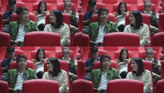亚洲的中国年轻夫妇在电影院等电影的时候，享受着彼此的陪伴高清在线视频素材下载