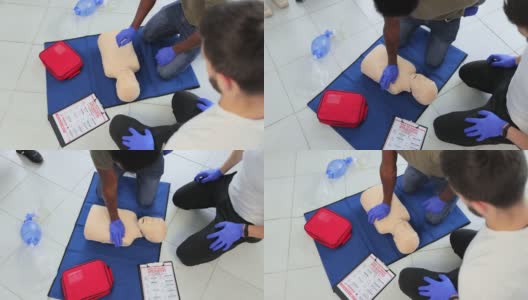 特写学生练习CPR胸部按压青少年假人。高清在线视频素材下载