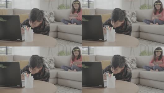 亚洲十多岁的男孩在家用笔记本电脑视频通话，使用zoom在线虚拟课堂，孩子们在家上学，新冠疫情期间远程学习，新常态概念高清在线视频素材下载