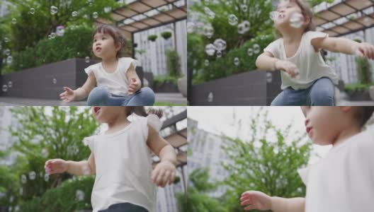 小女孩在公园里玩泡泡高清在线视频素材下载