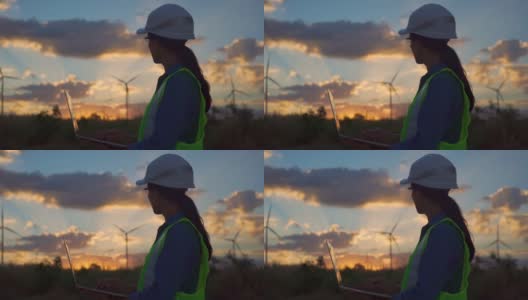 女性工程师使用智能手机在风力涡轮机农场工作的视频。高清在线视频素材下载
