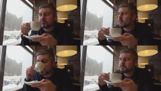 一个成年人在咖啡馆里用一个白色的杯子喝茶高清在线视频素材下载