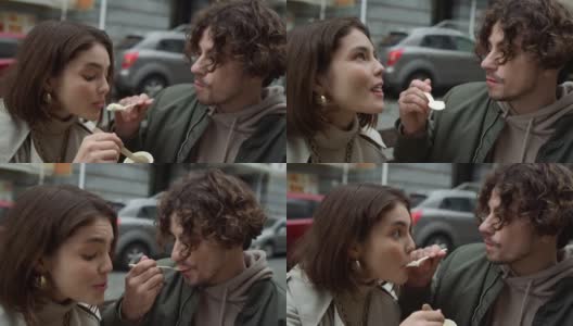 一对可爱的夫妇在街上吃冰淇淋。情侣户外约会。高清在线视频素材下载