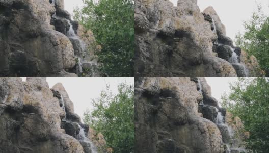 水从石头上流下，形成一个小瀑布。用慢动作拍摄水流高清在线视频素材下载