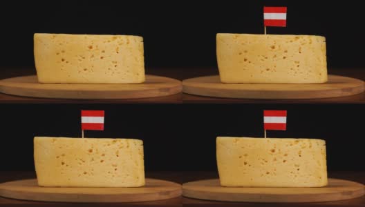 男人的手把小牙签和奥地利国旗放在奶酪上。高清在线视频素材下载