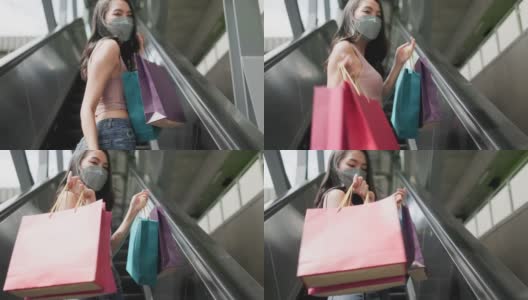 新常态购物，亚洲女性购物在服装商店与面膜。高清在线视频素材下载
