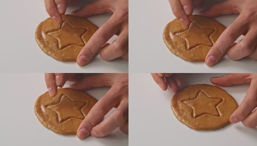 男人的手会掰出星星形状的糖饼干。高清在线视频素材下载
